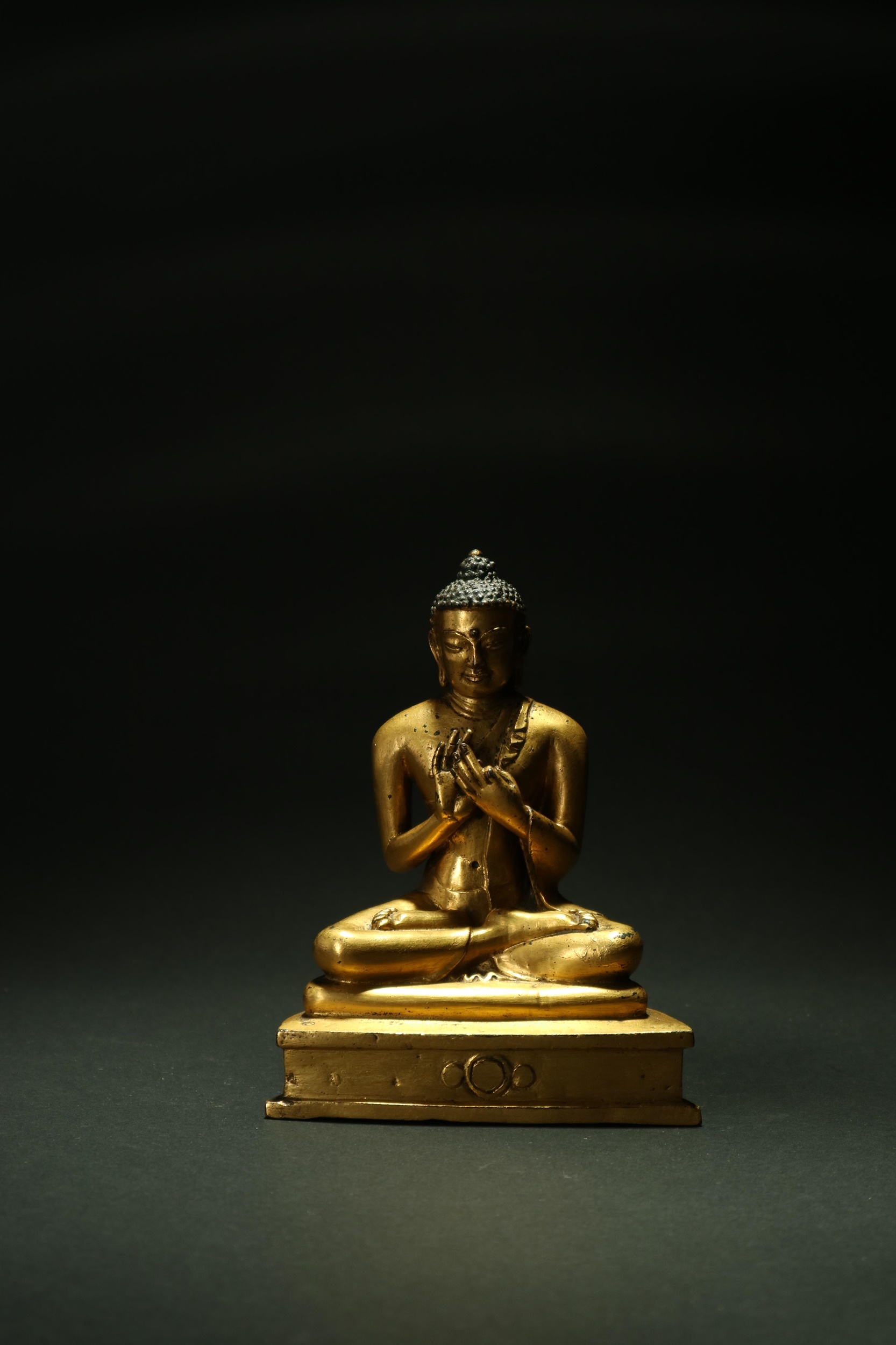 A good Tibetan gilt copper figure of Shakyamuni Buddha 15th century