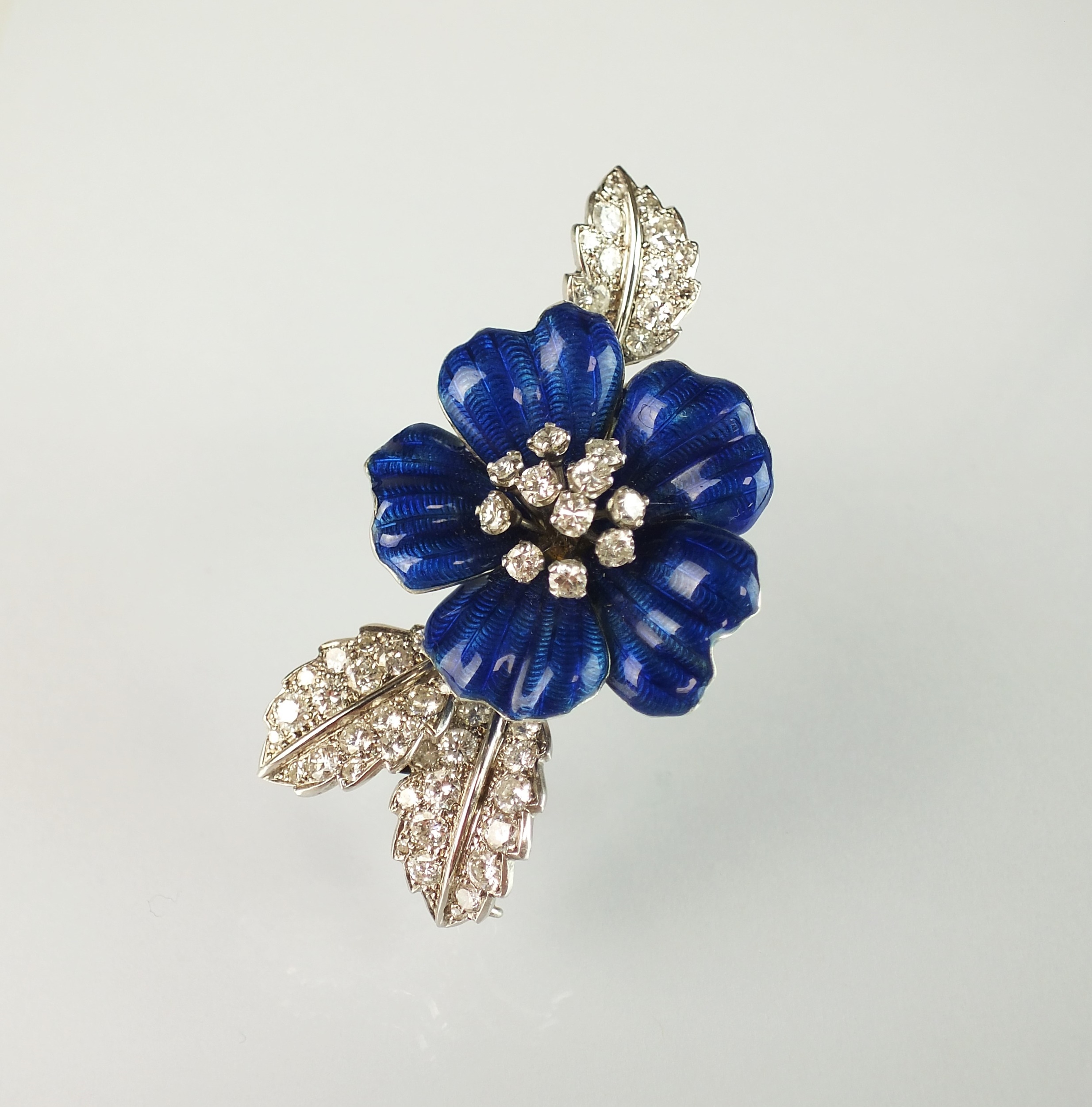 Lot 34 16/06/2021- A diamond and blue enamel flower brooch by Boucheron