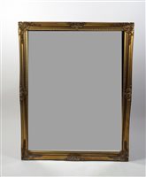 Lot 16 - A modern gilt framed wall mirror, the bevelled...