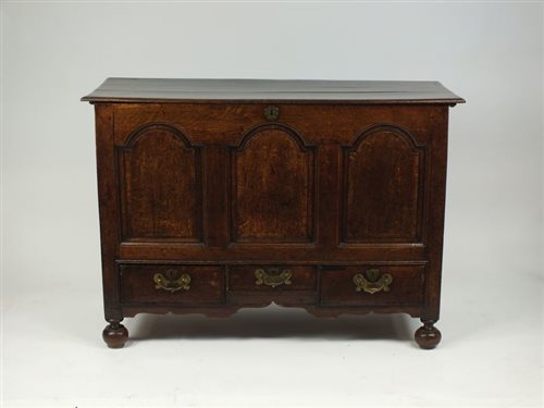 Lot 9 - A George III oak mule chest, the beveled plank...