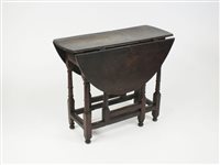 Lot 261 - A 17th century and later drop leaf table, the...