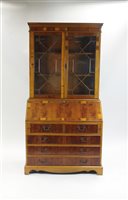 Lot 360 - A reproduction walnut bureau bookcase, with...