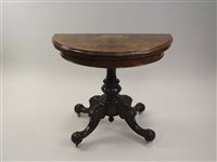 Lot 490 - A Victorian figured walnut fold-over top card...