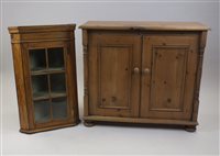 Lot 77 - A modern pine freestanding double door cabinet...