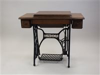 Lot 81 - An oak framed Singer treadle sewing machine on...