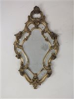 Lot 93 - A Venetian style wall mirror in gilt foliate...