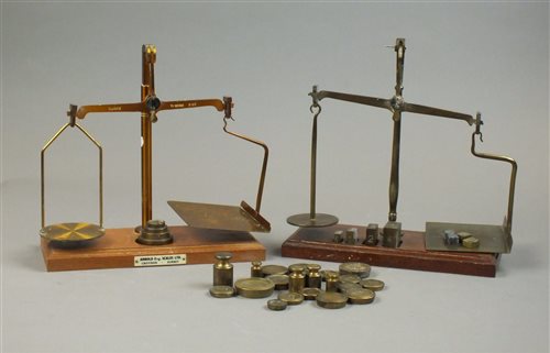 Lot 247 - Two sets of brass postal scales and weights,...
