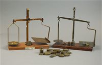 Lot 247 - Two sets of brass postal scales and weights,...