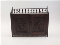 Lot 250 - An Art Nouveau carved walnut two door wall...