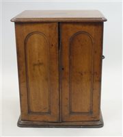 Lot 32 - A Victorian oak silver cabinet, the two arched...