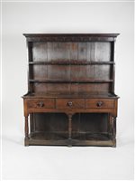 Lot 221 - A George III oak dresser, the moulded cornice...