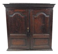 Lot 217 - A George III oak hanging cabinet