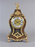 Lot 213 - A Louis XV style scarlet boulle mantel clock