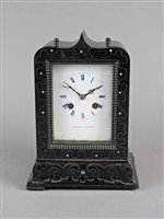 Lot 214 - A French ebonised and brass strung mantel clock