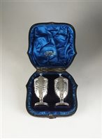 Lot 75 - A cased pair of silver pepperettes