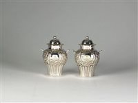 Lot 78 - A pair of silver pepper pots