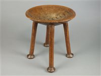 Lot 250 - A West African carved wood and copper stapled stool