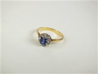 Lot 101 - A sapphire and diamond cluster ring