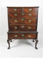 Lot 518 - A walnut crossbanded chest on stand