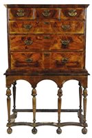 Lot 299 - An oak and walnut veneered chest on stand