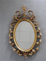 Lot 320 - A George III carved gilt wood oval wall mirror