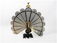 Lot 336 - A gilt brass and cast iron peacock fire screen