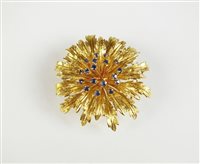 Lot 228 - A sapphire set flower brooch