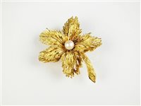 Lot 132 - A pearl set flower brooch