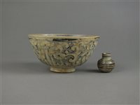 Lot 77 - A South East Asian porcelain bowl, oil jar and a Chinese saucer