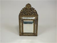 Lot 359 - A 19th Century pressed-brass cushion mirror