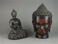 Lot 86 - A Khmer lacquered wood head of Buddha and a resin figure of Buddha