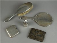 Lot 48 - A group of silver to include a cigarette box, dressing mirror and brush, Indian cigarette box and pepper pot