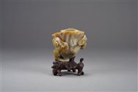 Lot 81 - A Chinese carved red and grey agate lotus
brush washer