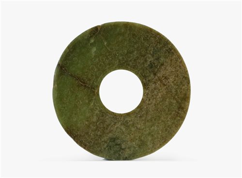 Lot 84 - A Chinese dark green jade disc, Bi