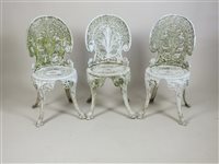 Lot 372 - A set of three painted cast aluminium garden chairs