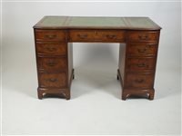 Lot 385 - A reproduction figured walnut pedestal desk