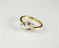 Lot 192 - A three stone diamond crossover ring