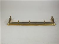 Lot 411 - An Edwardian brass D shaped telescopic fire curb