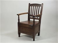 Lot 478 - Early 19th century oak commode arm chair