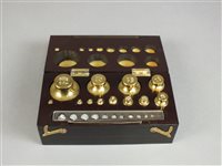 Lot 239 - A bakelite case set of graduated brass weights