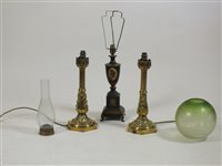 Lot 416 - A pair of cast brass foliate wrapped candle sticks