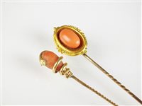Lot 257 - Two coral set stick pins
