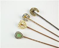Lot 54 - A collection of four stick pins