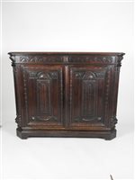 Lot 424 - A Victorian carved oak side cabinet, the canted rectangular top above a lunette carved frieze