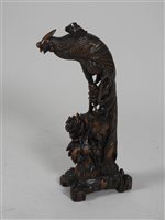 Lot 437 - Chinese carved hardwood peacock on a foliate plinth, 51cm high