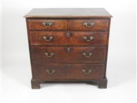 Lot 431 - A George III oak chest of drawers, the rectangular bevelled top