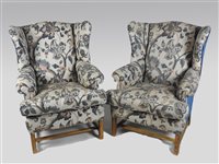 Lot 429 - A pair of George III style wing back armchairs