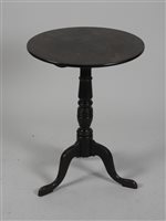 Lot 430 - A George III mahogany tripod table, the circular tilt-top above a ring turned baluster column