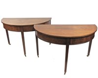 Lot 593 - A pair of mahogany half round side tables