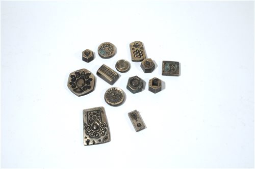 Lot 302 - A collection of thirteen Indian antique incised brass sweet moulds
